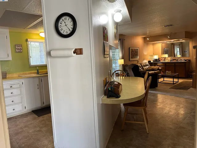 a view of a kitchen area with furniture and a clock