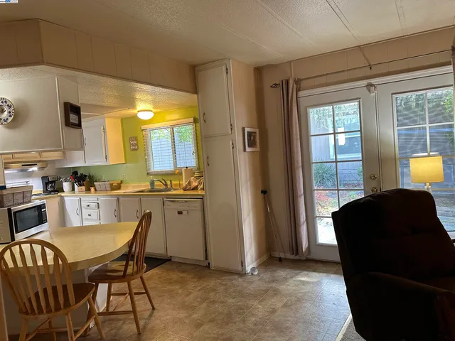 a view of a dining room with furniture and window