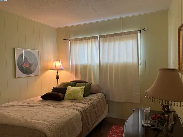 a bedroom with a bed and a lamp