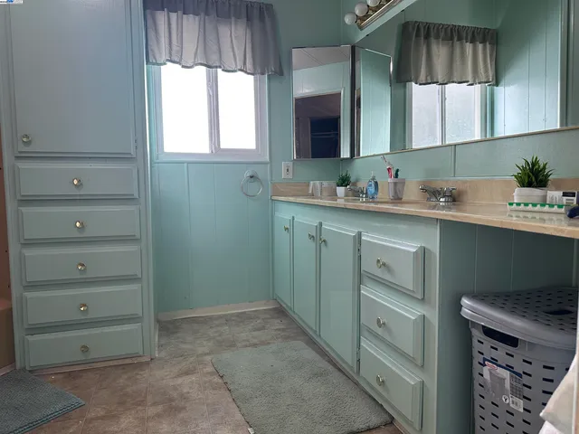 a kitchen with cabinets appliances and a window