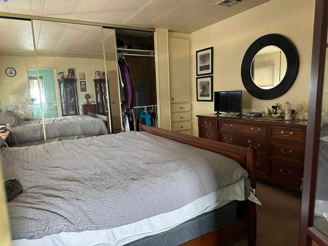 a bedroom with a bed and a dresser