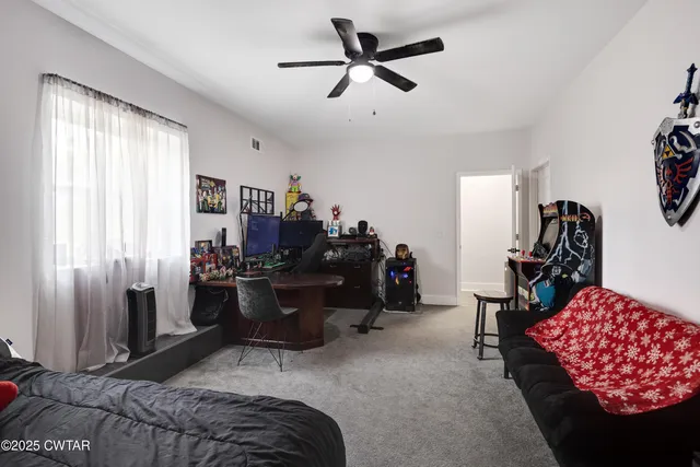 a bedroom with furniture and a window