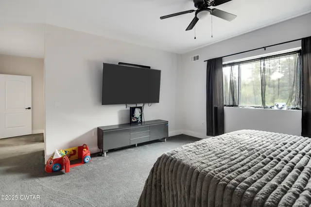 a bedroom with bed and window