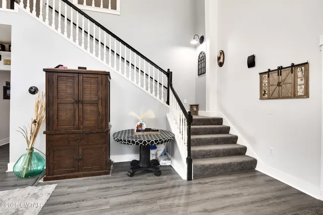 a view of entryway and hall with wooden floor