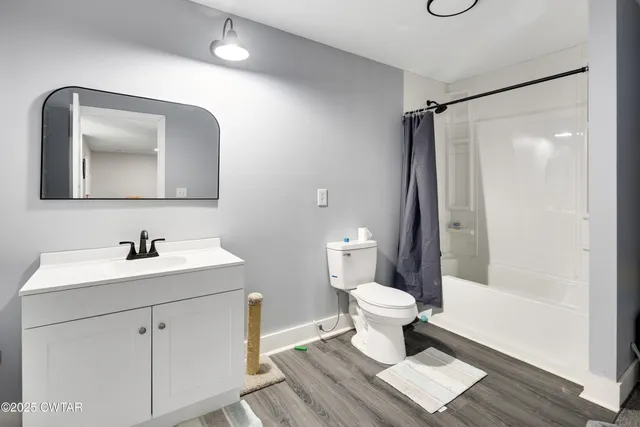 a bathroom with a toilet sink and a mirror