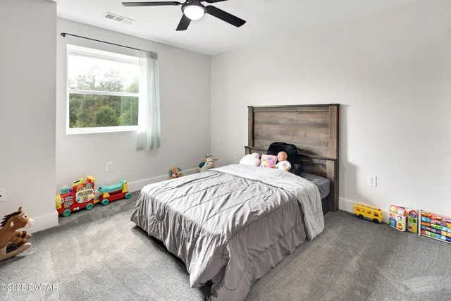 a bed sitting in a bedroom next to a window