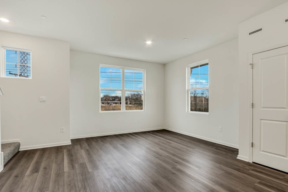 561 Yosemite Way Mundelein, IL 60060 - Photo 5 of 48 a view of an empty room with wooden floor and a window