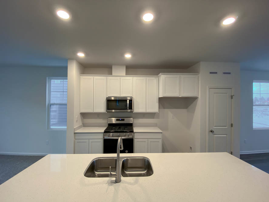561 Yosemite Way Mundelein, IL 60060 - Photo 9 of 48 a kitchen with stainless steel appliances kitchen island sink refrigerator and stove