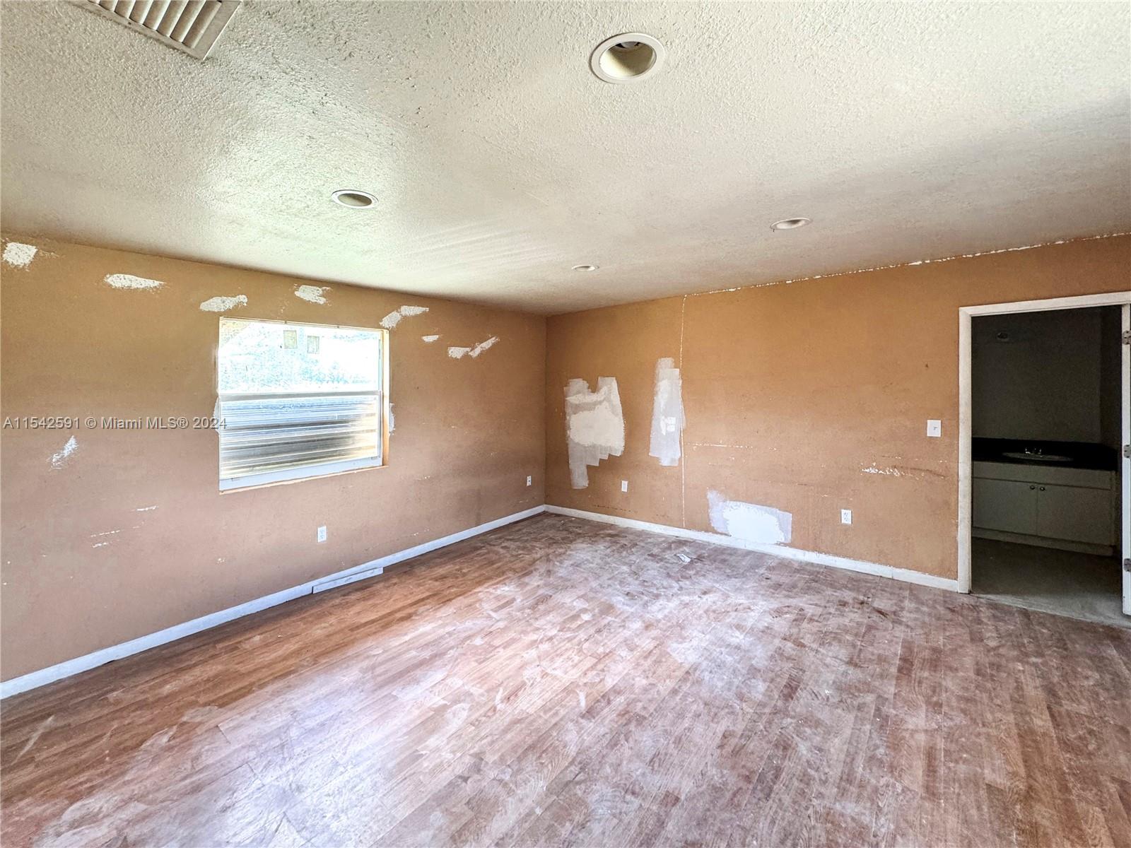 657 Southwest 7th Street Homestead, FL 33030 - Photo 15 of 33 a view of an empty room with a window