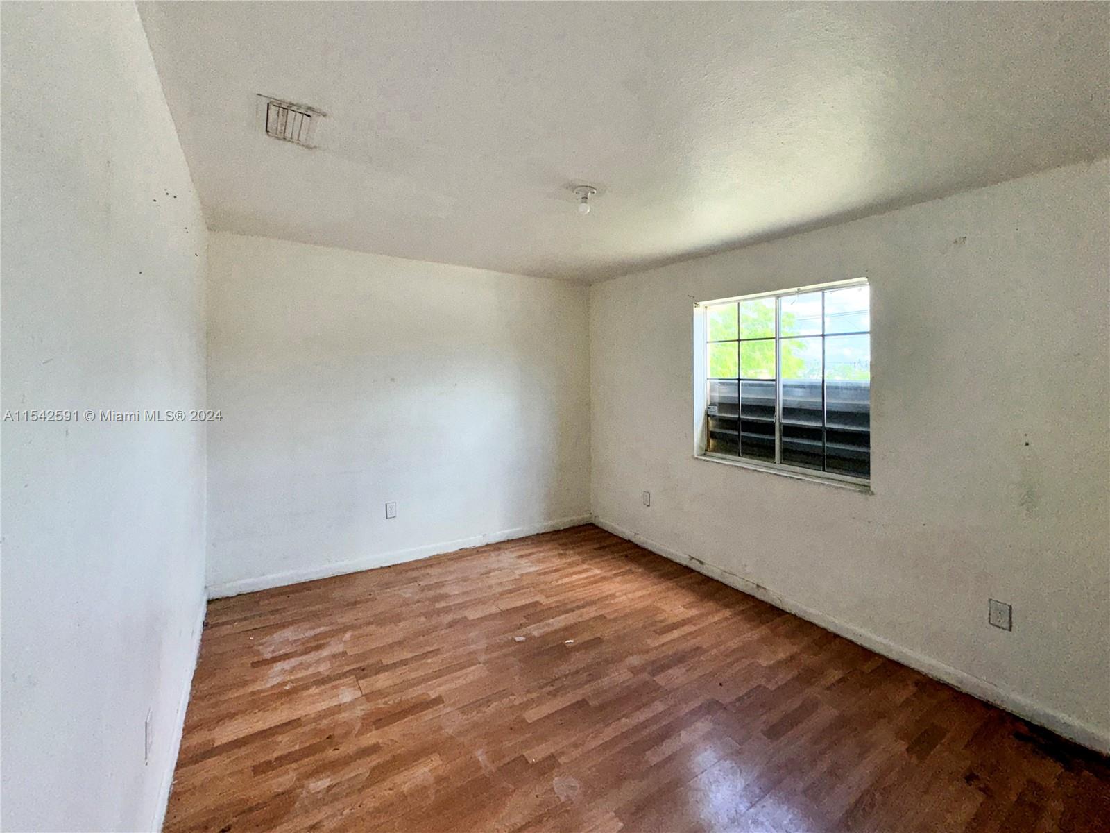 657 Southwest 7th Street Homestead, FL 33030 - Photo 21 of 33 an empty room with windows