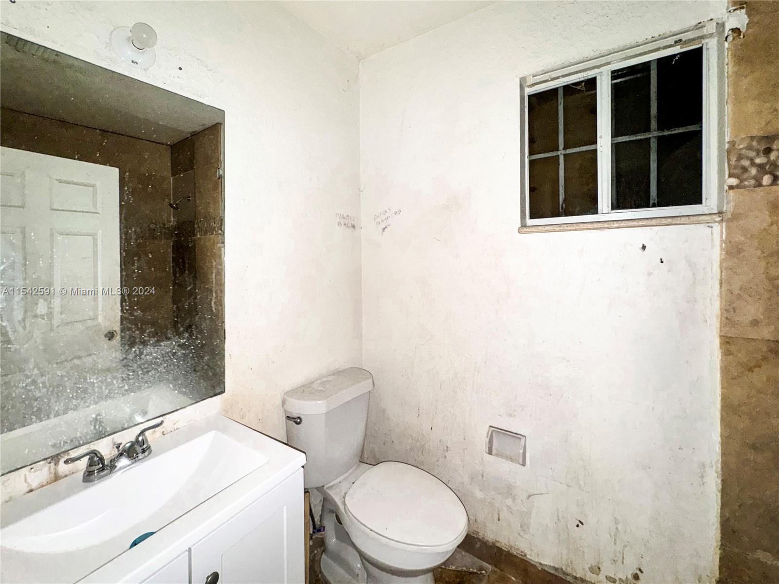 657 Southwest 7th Street Homestead, FL 33030 - Photo 22 of 33 a white toilet sitting next to a bathroom sink