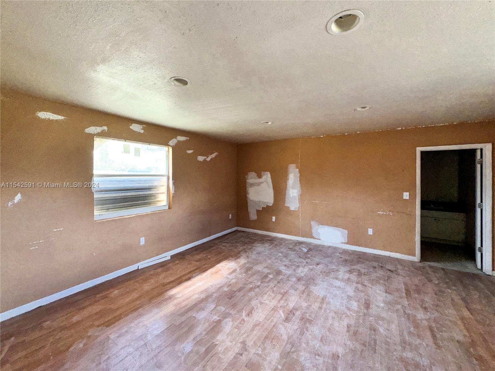 657 Southwest 7th Street Homestead, FL 33030 - Photo 25 of 33 an empty room with windows and closet