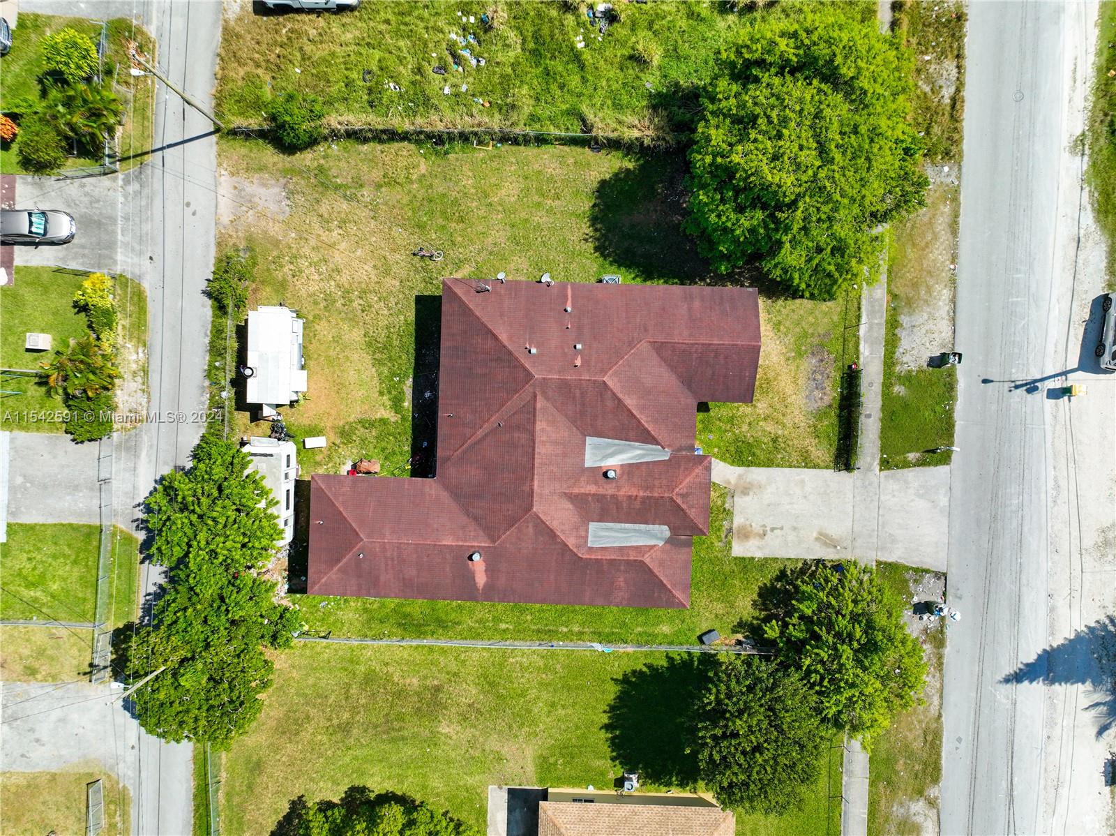 657 Southwest 7th Street Homestead, FL 33030 - Photo 3 of 33 an aerial view of a house with outdoor space and a lake view
