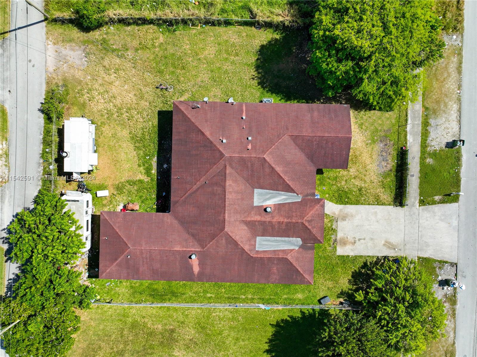 657 Southwest 7th Street Homestead, FL 33030 - Photo 4 of 33 an aerial view of a house with a garden and a yard
