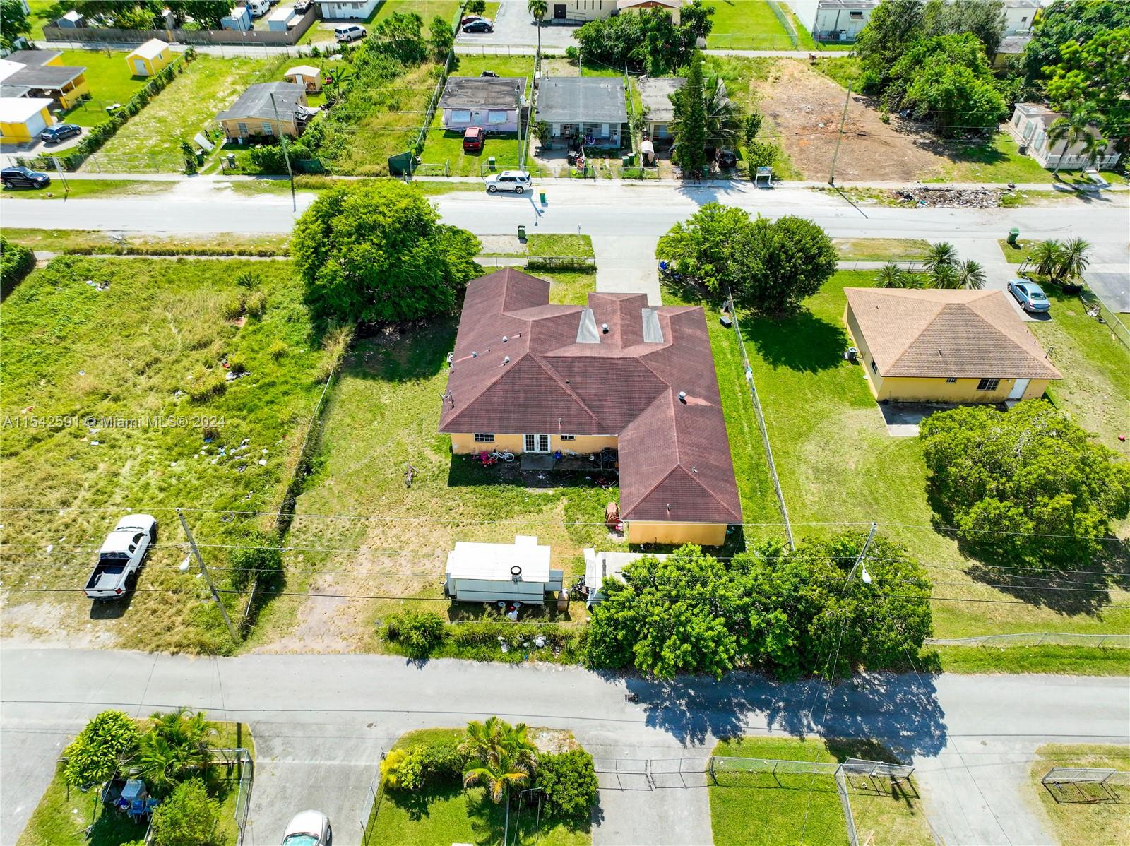 657 Southwest 7th Street Homestead, FL 33030 - Photo 5 of 33 an aerial view of a house with swimming pool a yard and plants