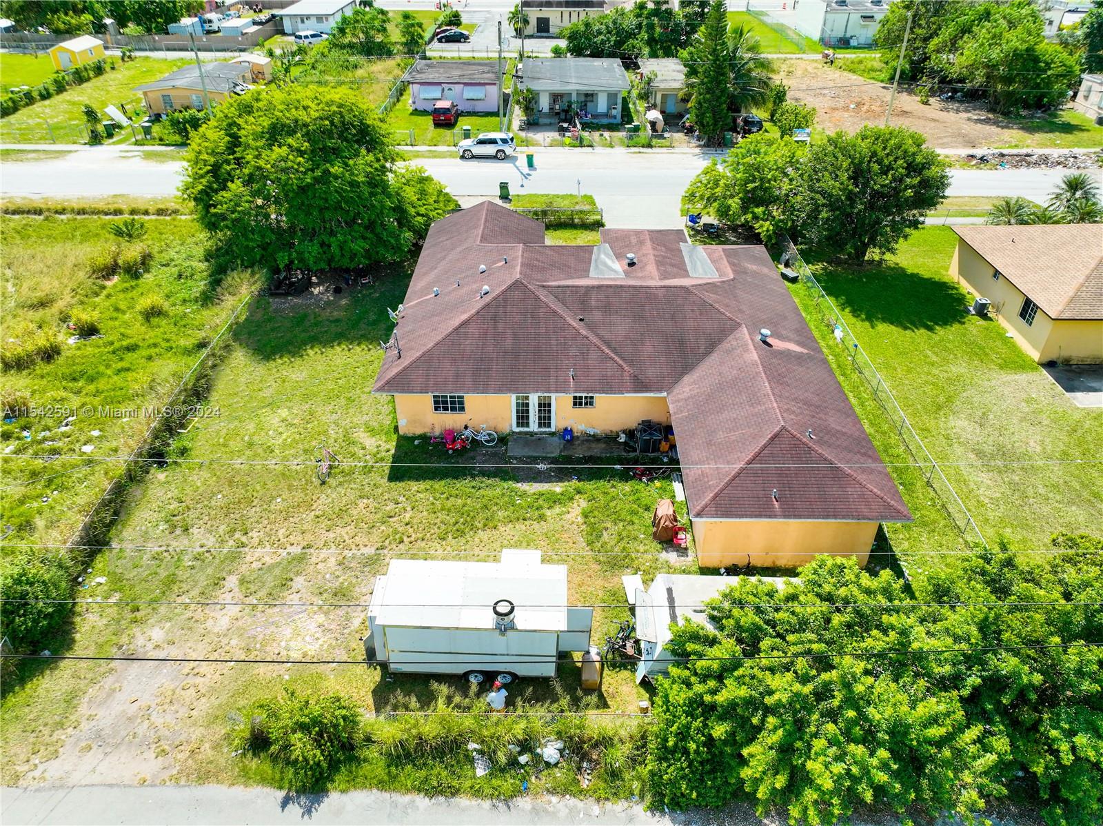 657 Southwest 7th Street Homestead, FL 33030 - Photo 7 of 33 an aerial view of a house with swimming pool garden and lake view