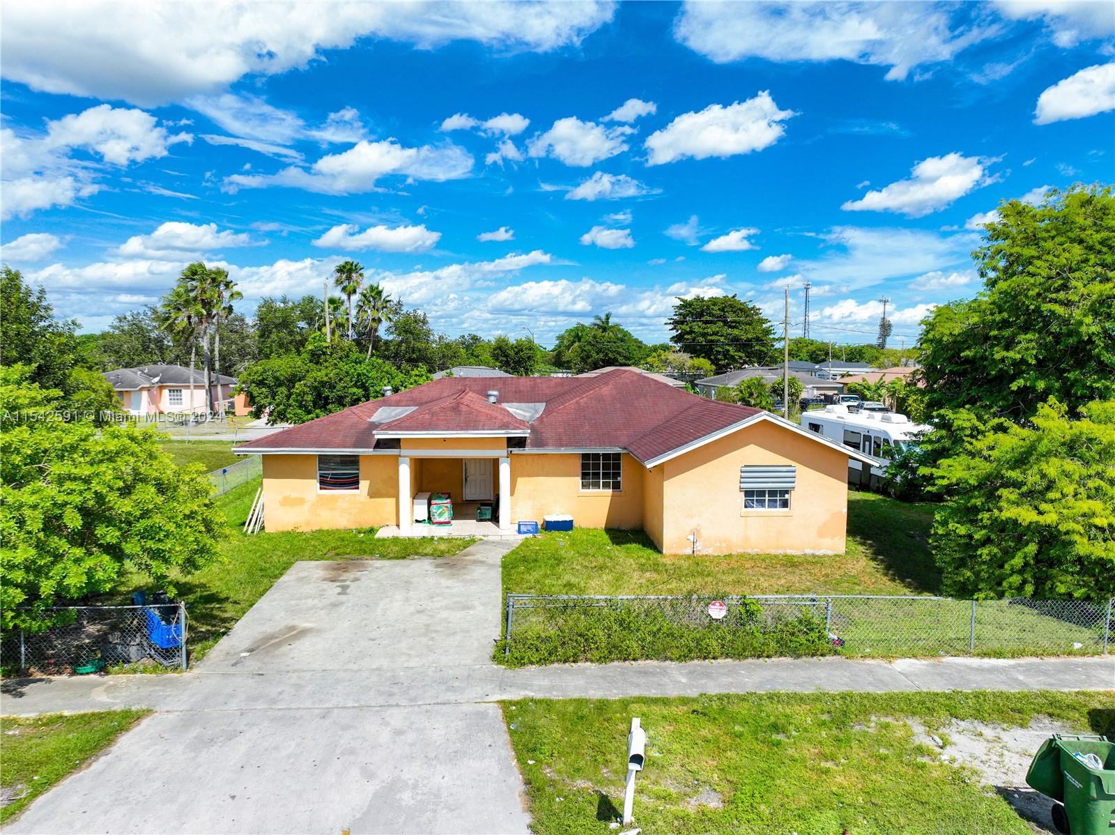 657 Southwest 7th Street Homestead, FL 33030 - Photo 9 of 33 a front view of a house with a yard