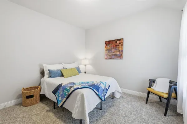 a bedroom with a bed and a chair