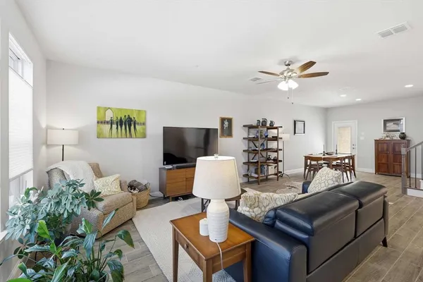 a living room with furniture and wooden floor