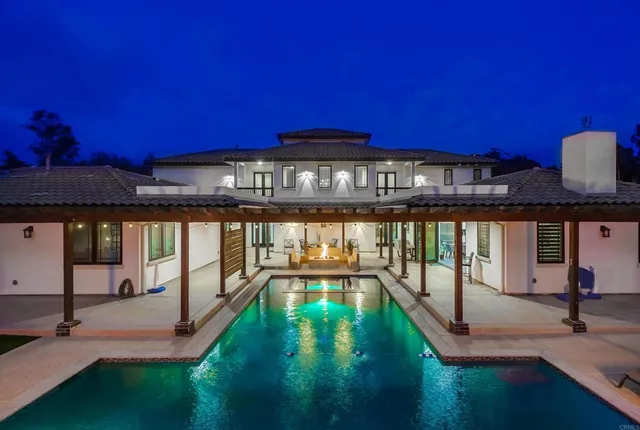 a view of a swimming pool with outdoor seating