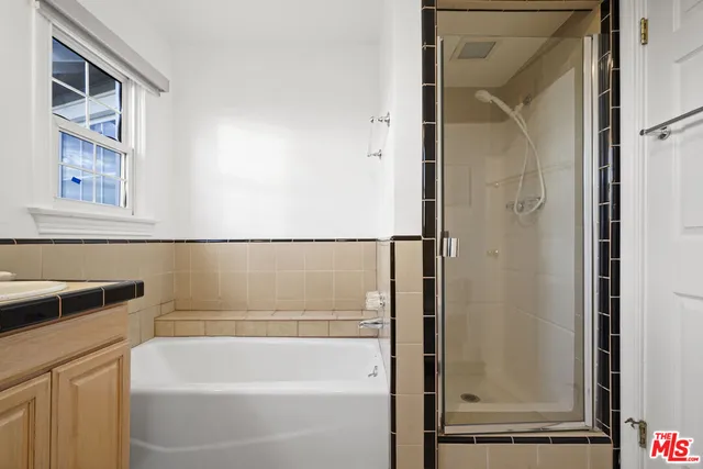 a bathroom with a bathtub and a shower