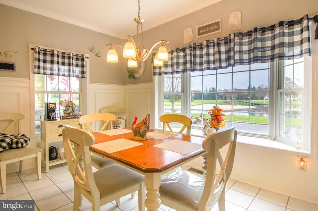 a view of a dining room with furniture a chandelier and wooden floor