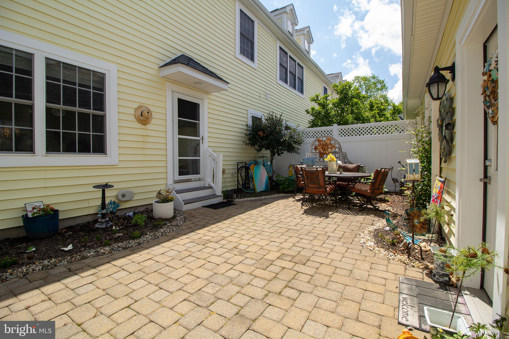 32377 Back Nine Way, Unit 3747 Long Neck, DE 19966 - Photo 12 of 41 a backyard of a house with outdoor seating