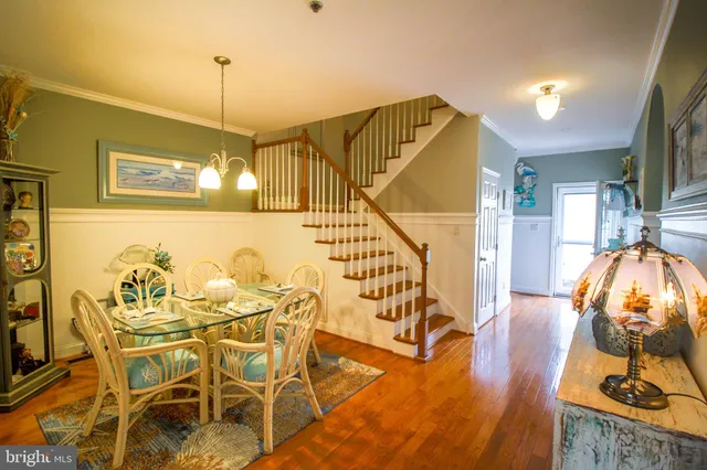 a view of a dining room and hall with wooden floor