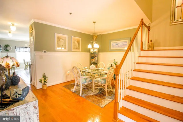 a dining room with furniture and wooden floor