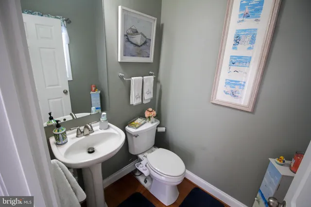 a bathroom with a sink mirror and toilet
