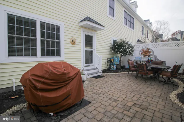 a view of a backyard with table and chairs