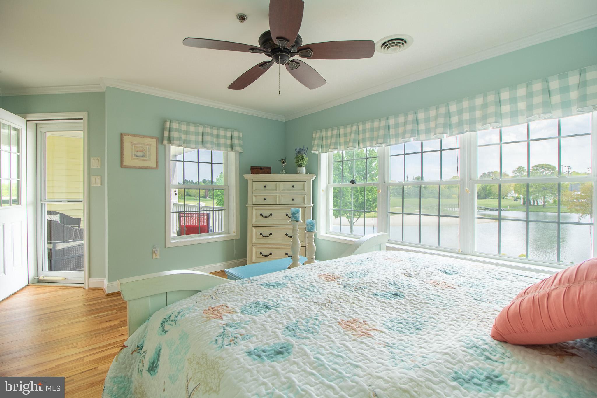 32377 Back Nine Way, Unit 3747 Long Neck, DE 19966 - Photo 26 of 41 a bedroom with a large bed and a large window