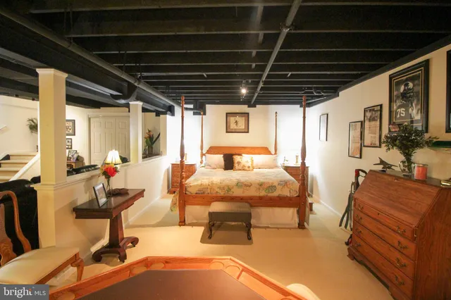 a bedroom with furniture and a flat screen tv