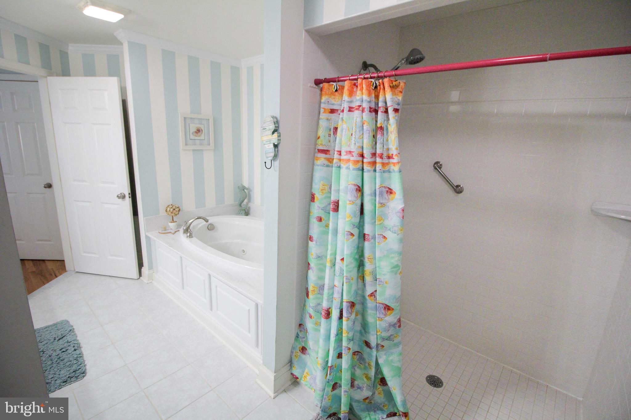 32377 Back Nine Way, Unit 3747 Long Neck, DE 19966 - Photo 28 of 41 a bathroom with a shower and a tub