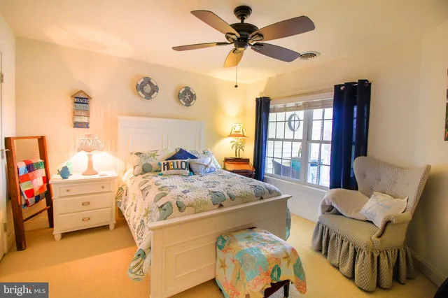 a bed room with a bed window and a chair