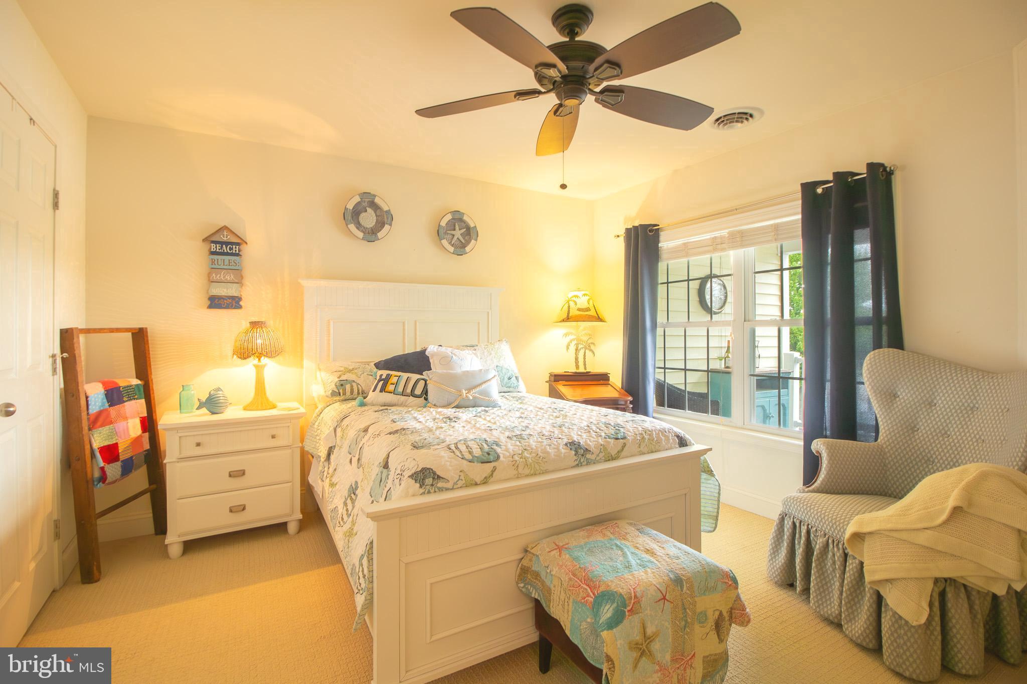 32377 Back Nine Way, Unit 3747 Long Neck, DE 19966 - Photo 35 of 41 a bed room with a bed and a chandelier