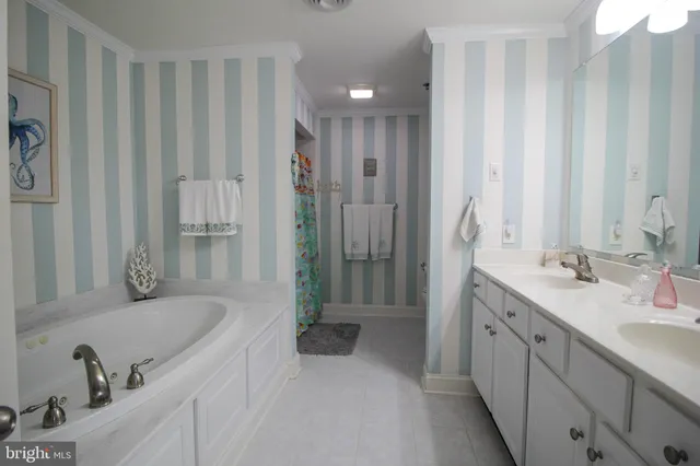 a bathroom with a tub sink and mirror