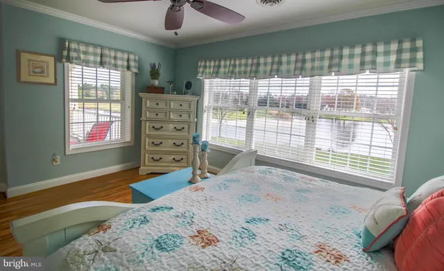 a bedroom with a bed and a large window