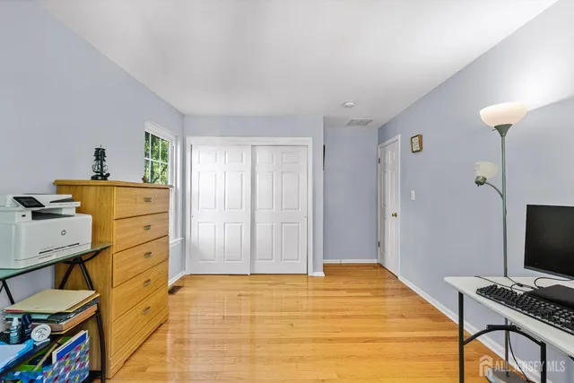 a bed sitting in a bedroom next to a window