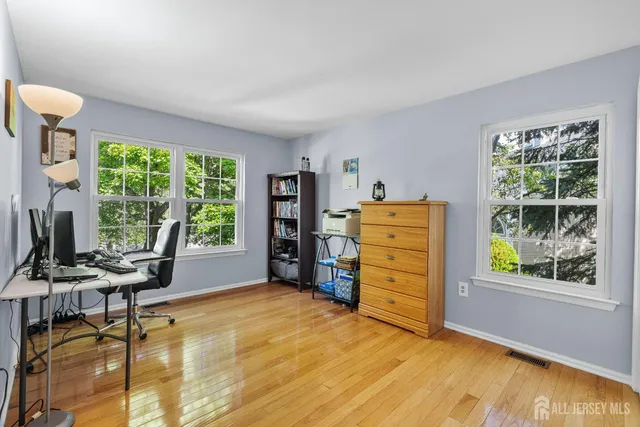 a bedroom with a bed and a lamp