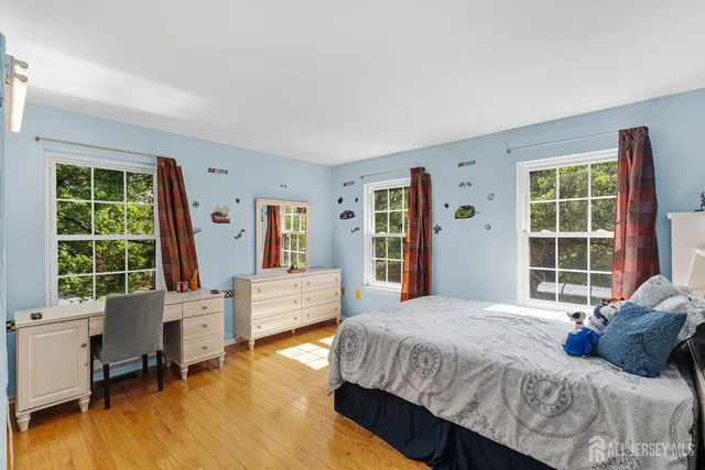 a bathroom with a sink double vanity granite tub and a mirror