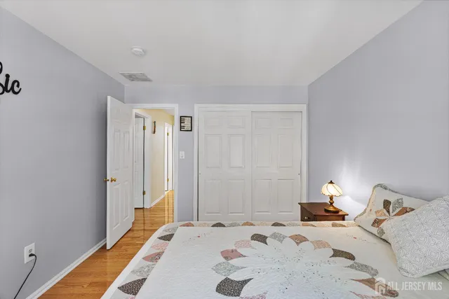 a bedroom with a large bed and a chandelier