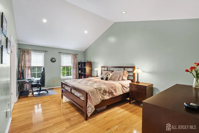 a spacious bathroom with a granite countertop double vanity sink a mirror and a toilet