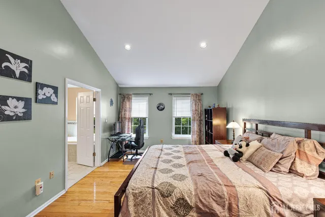 a spacious bathroom with a granite countertop sink mirror and shower