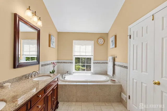 a room with furniture pool table flat screen tv and windows