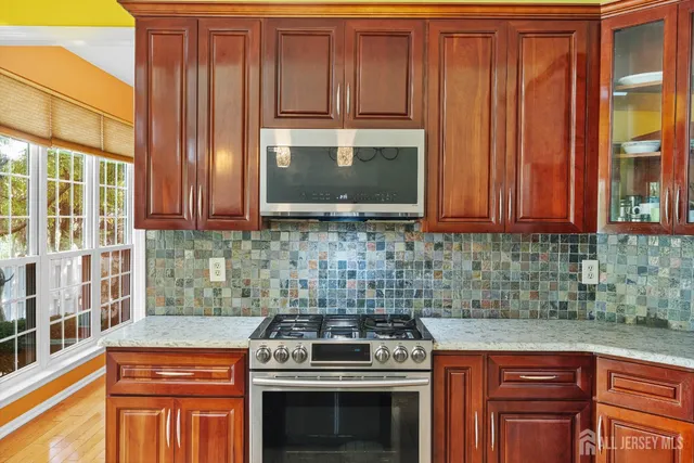 a kitchen with stainless steel appliances a table and chairs