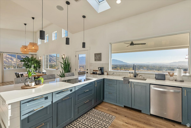1800 Spring Oaks Drive Springville, UT 84663 - Photo 16 of 68 Kitchen with a skylight, light wood-style flooring, dishwasher, a peninsula, and pendant lighting