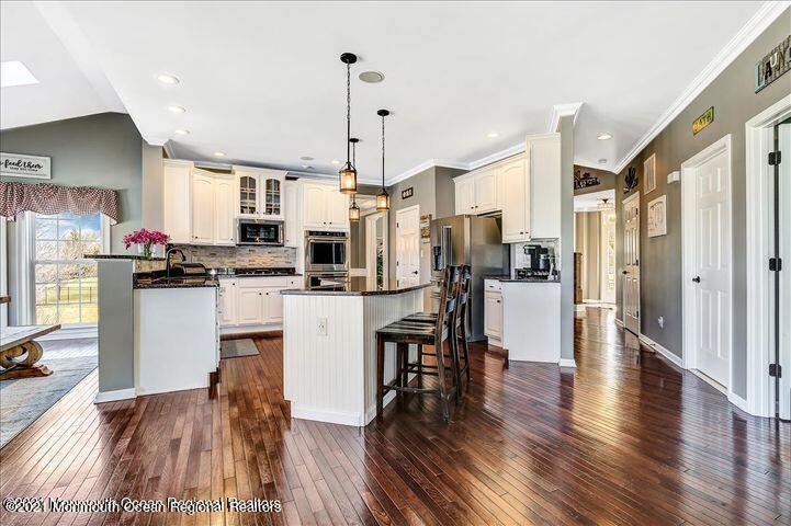 5 Jake Drive Cream Ridge, NJ 08514 - Photo 13 of 64 a kitchen with stainless steel appliances kitchen island granite countertop a refrigerator a oven a stove top oven and a dining table with wooden floor
