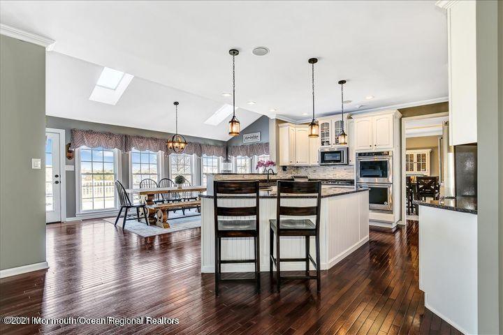 5 Jake Drive Cream Ridge, NJ 08514 - Photo 14 of 64 a open kitchen with stainless steel appliances granite countertop a stove top oven a refrigerator a dining table and chairs with wooden floor
