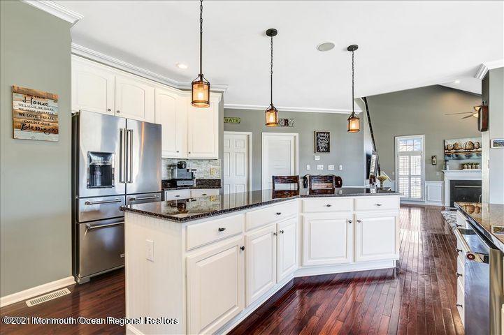 5 Jake Drive Cream Ridge, NJ 08514 - Photo 16 of 64 a kitchen with stainless steel appliances kitchen island granite countertop a refrigerator a stove and white cabinets with wooden floor